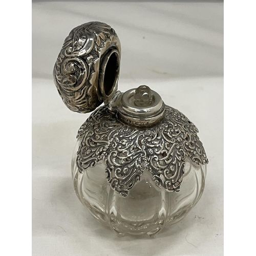 25 - A HALLMARKED SILVER DECORATIVE PERFUME BOTTLE WITH STOPPER