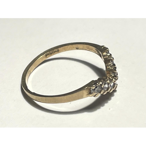 516 - A 9 CARAT GOLD WISHBONE RING WITH CUBIC ZIRCONIAS SIZE L