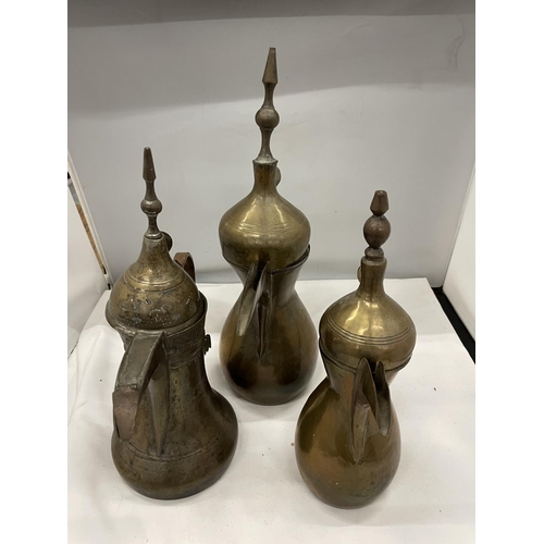 54 - THREE TURKISH BRASS DALLAH JUGS