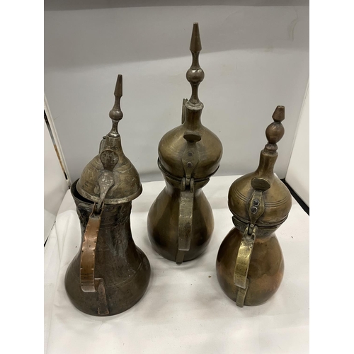 54 - THREE TURKISH BRASS DALLAH JUGS