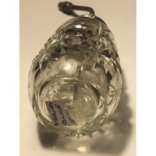 654 - A VINTAGE CUT GLASS PERFUME BOTTLE WITH A STERLING SILVER TOP