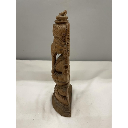 7 - A CARVED WOOD GANESHA FIGURE