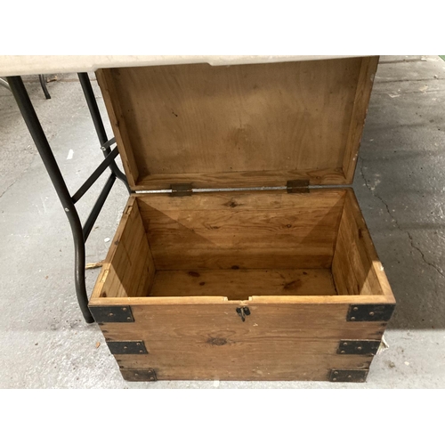 102 - A PINE SMALL CHEST WITH METAL BANDING AND HANDLES HEIGHT 34CM, WIDTH 54CM, DEPTH 34CM