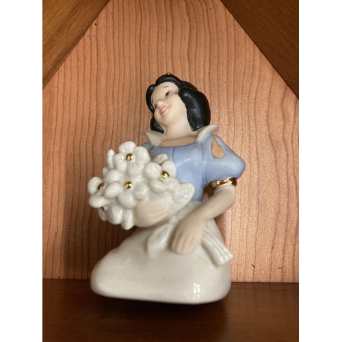 140 - A WOODEN HOUSE SHAPED DISPLAY CASE CONTAINING LENNOX DISNEY MODELS OF SNOW WHITE AND THE SEVEN DWARF... 