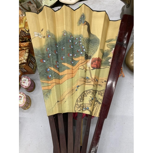 180 - TWO LARGE HANDPAINTED EASTERN FANS AND A HANDPAINTED PARASOL