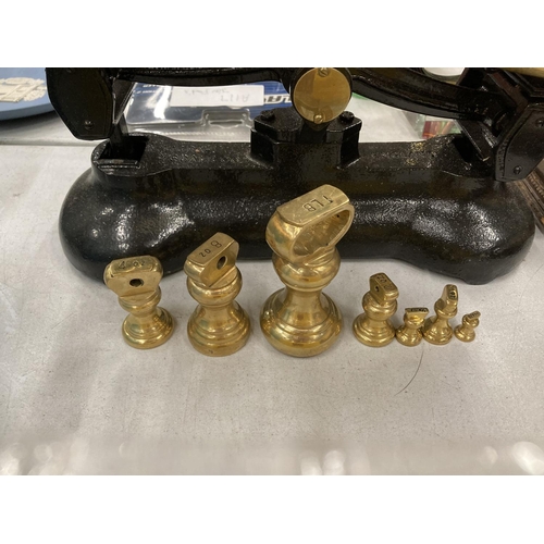 218 - A SET OF VINTAGE LIBRA CAST AND BRASS SCALES WITH WEIGHTS