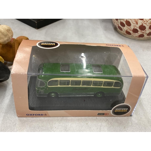 242 - FOUR 1/76 SCALE DIECAST MODELS TO INCLUDE TWO BOXED OXFORD DIECAST BUSES AND TWO UNBOXED CORGI TRAMS