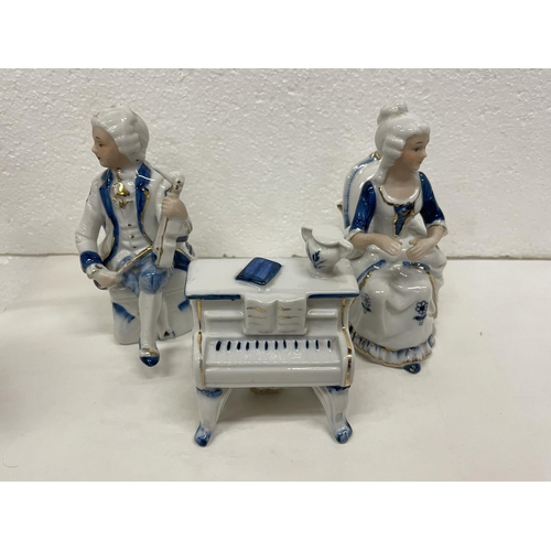 487 - THREE PORCELAIN MUSICAL SCENE FIGURES COMPRISING OF A GENT PLAYING THE VIOLIN AND A LADY PLAYING THE... 