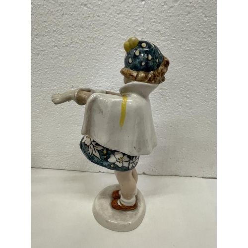 489 - A GOLDSHIEIDER FIGURE OF GIRL PUTTING ON GLOVES HEIGHT 23CMS