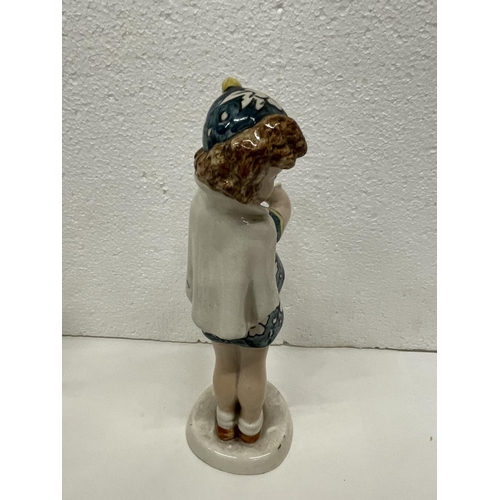 489 - A GOLDSHIEIDER FIGURE OF GIRL PUTTING ON GLOVES HEIGHT 23CMS