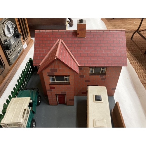 269 - A MODEL OF A FARMHOUSE AND STABLE BLOCK WITH A LANDROVER AND HORSEBOX AND A CAR AND CARAVAN