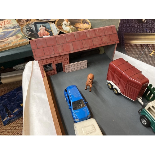 269 - A MODEL OF A FARMHOUSE AND STABLE BLOCK WITH A LANDROVER AND HORSEBOX AND A CAR AND CARAVAN