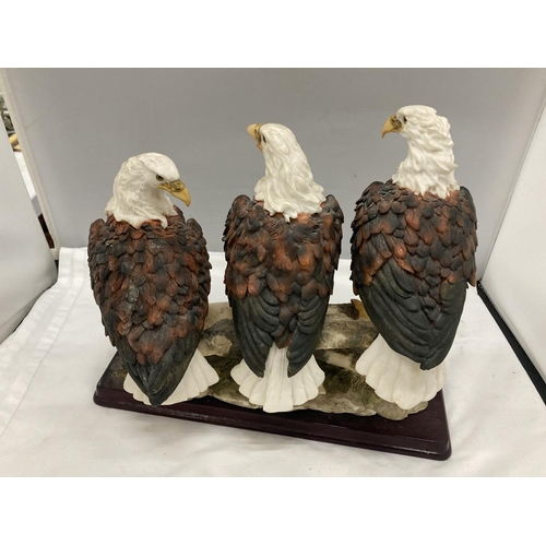 296 - A RESIN MODEL OF A GROUP OF THREE BALD EAGLES ON A BRANCH BY THE JULIANA COLLECTION HEIGHT 29CM, WID... 