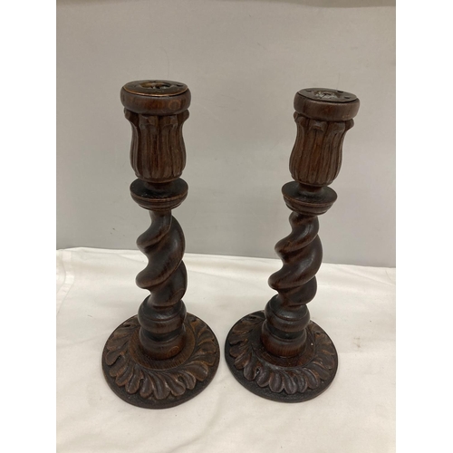 299 - A PAIR OF WOODEN BARLEY TWIST CANDLESTICKS