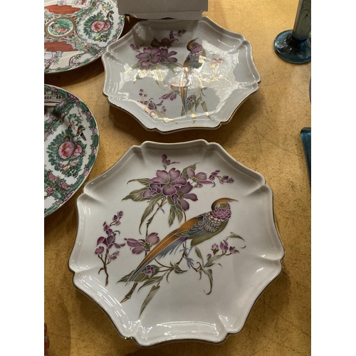 738 - FOUR ORIENTAL PLATES, TWO WITH ORANGE DESIGN, TWO WITH GREEN AND CRIMSON FLOWERS, BIRDS AND FIGURES ... 