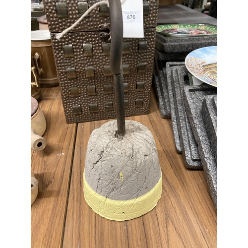 875 - A CONCRETE DOORSTOP WITH METAL HANDLE