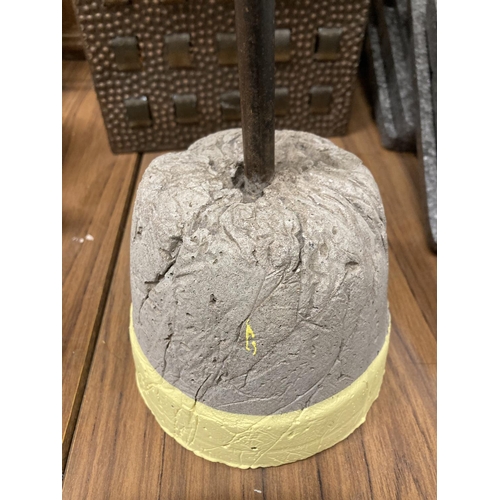 875 - A CONCRETE DOORSTOP WITH METAL HANDLE