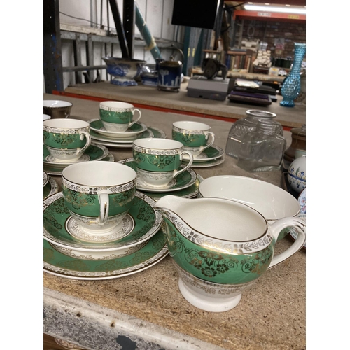 944 - A DUCAL WARE TEASET IN CREAM, GOLD AND GREEN TO INCLUDE SIX TRIO, MILK & SUGAR