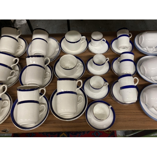 958 - A LARGE QUANTITY OF EMPIRE WARE WHITE AND NAVY CUPS AND SAUCERS