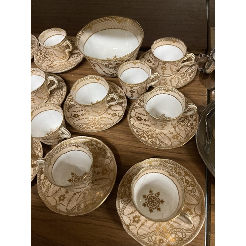 961 - AN ANTIQUE BEIGE WHITE AND GOLD TEASET CONSISTING OF MAINLY CUPS AND SAUCERS WITH SUGAR BOWL