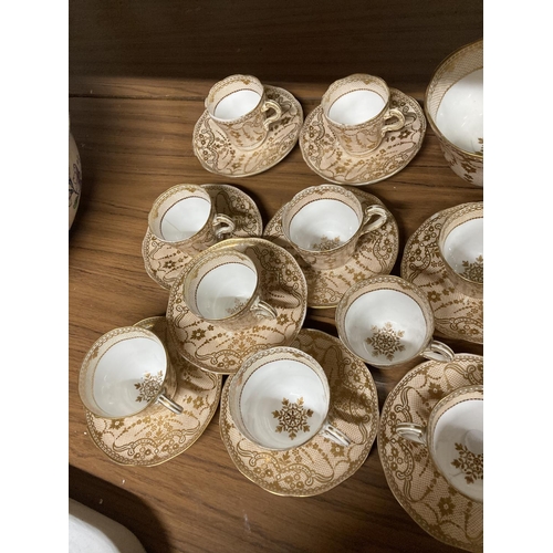 961 - AN ANTIQUE BEIGE WHITE AND GOLD TEASET CONSISTING OF MAINLY CUPS AND SAUCERS WITH SUGAR BOWL