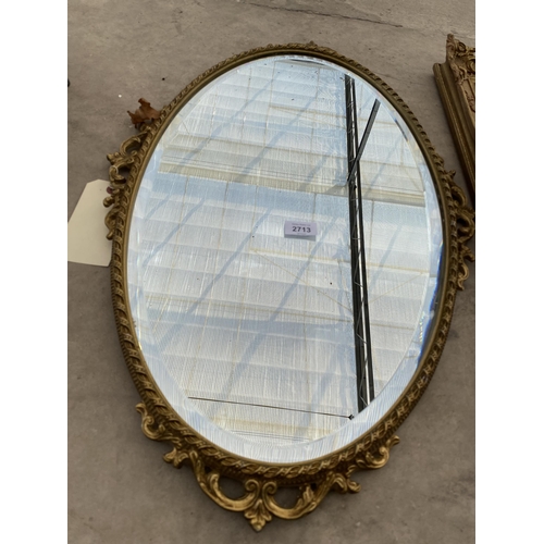 2713 - A MODERN OVAL GILT FRAMED WALL MIRROR, 30X18