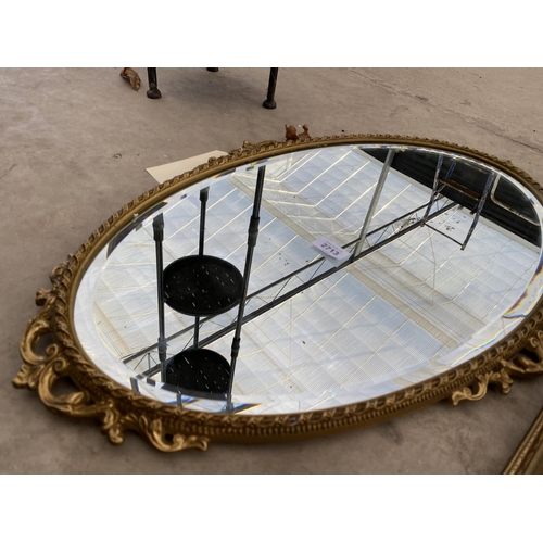 2713 - A MODERN OVAL GILT FRAMED WALL MIRROR, 30X18