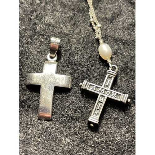 676 - FOUR MARKED SILVER NECKLACES TWO WITH CROSS PENDANTS