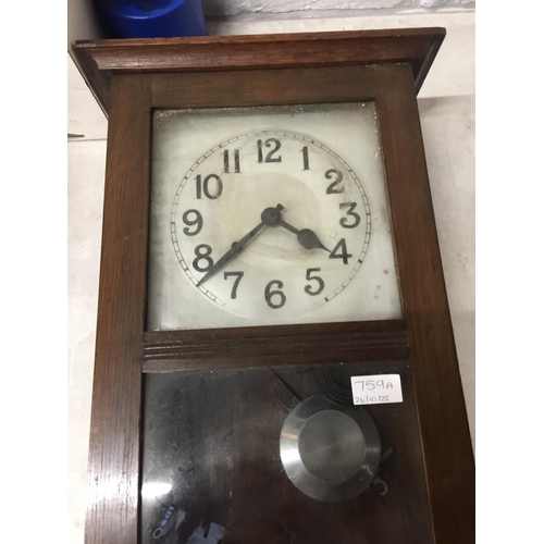 759A - A VINTAGE WALL CLOCK IN A MAHOGANY CASE WITH PENDULUM AND KEY