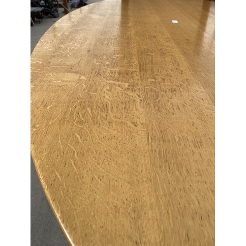 2717 - AN OVAL OAK DINING TABLE, 79X43