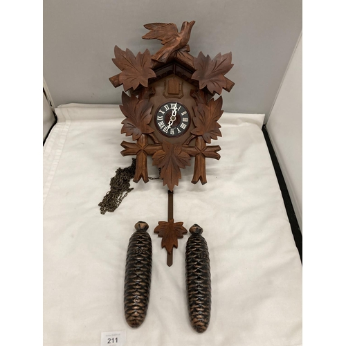 211 - A WOODEN CUCKOO CLOCK WITH PENDULUM AND CARVED LEAVES AND BIRD