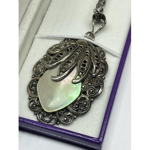 523 - A MARKED SILVER NECKLACE WITH A LARGE DECORATIVE MOTHER OF PEARL PENDANT IN A PRESENTATION BOX