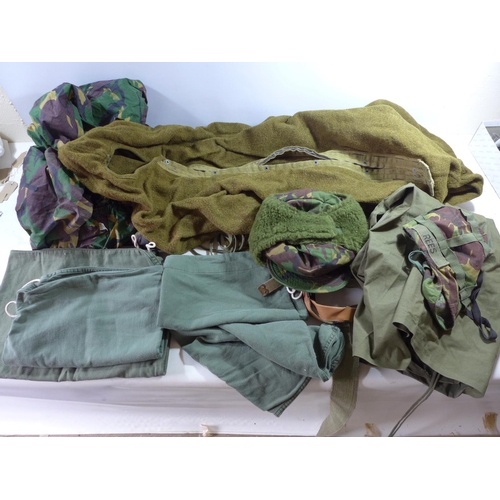 354 - A WOOLEN THERMAL SLEEPING BAG, ASSORTED CAMOUFLAGE CLOTHING, WEBBING, GUN SLIPCASE ETC