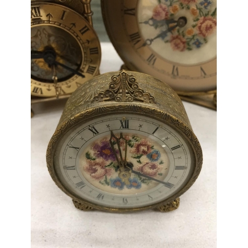 180 - THREE VINTAGE CLOCKS TO INCLUDE A BRASS LANTERN CLOCK, A PETIT POINT MANTLE CLOCK AND ALARM CLOCK