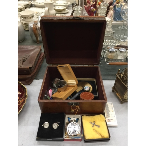 182 - A WOODEN BOX WITH DECORATIVE METAL FEATURES AND A QUANTITY OF COSTUME JEWELLERY, BADGES, WATCHES AND... 