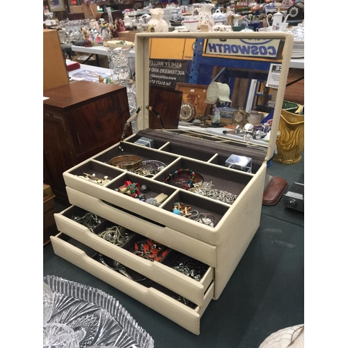 76 - A CREAM LEATHERETTE JEWELLERY BOX WITH THREE DRAWERS CONTAINING COSTUME JEWELLERY