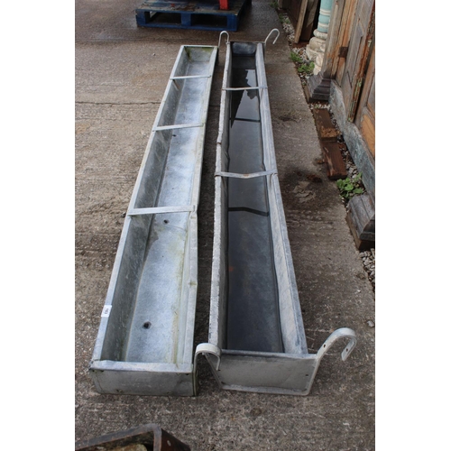 183 - TWO GLAVANISED HANG ON TROUGHS BOTH 9FT NO VAT