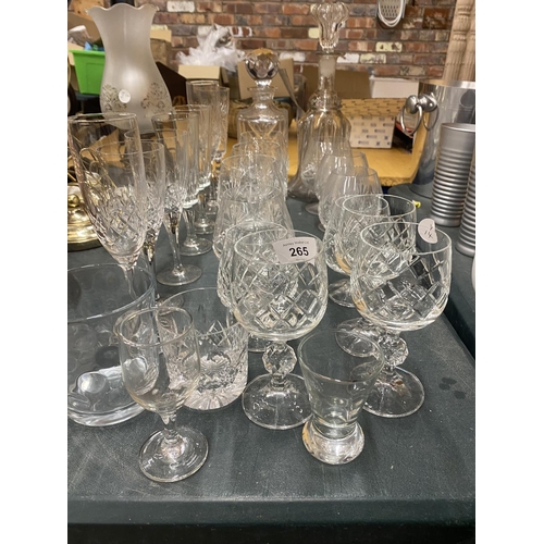 265 - A QUANTITY OF GLASSES TO INCLUDE DECANTERS, CHAMPAGNE FLUTES, BRANDY GLASSES, WINE GLASSES, ETC