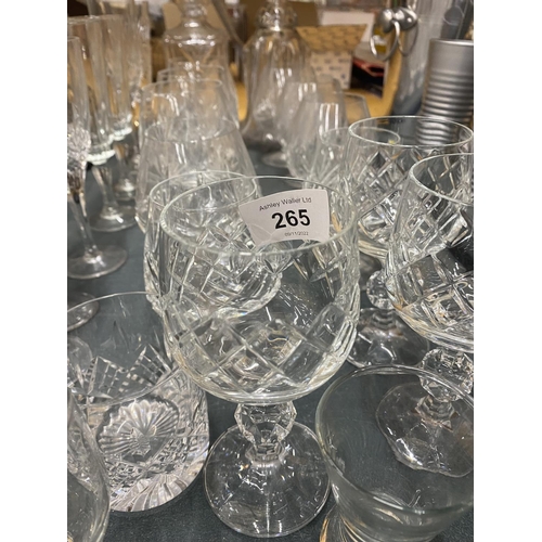 265 - A QUANTITY OF GLASSES TO INCLUDE DECANTERS, CHAMPAGNE FLUTES, BRANDY GLASSES, WINE GLASSES, ETC