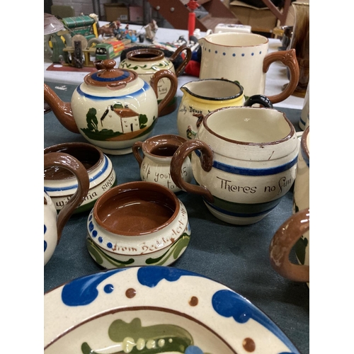 333 - A LARGE COLLECTION OF TORQUAY MOTTO WARE TO INCLUDE A TEAPOT, BOWLS, JUGS, CUPS, CANDLESTICKS, ETC