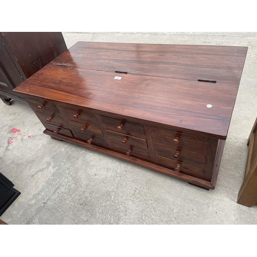 2665 - A MODERN HARDWOOD COFFEE TABLE WITH HINGED LID AND ENCLOSING TWELVE DRAWERS TO OTHER SIDE, 48X26