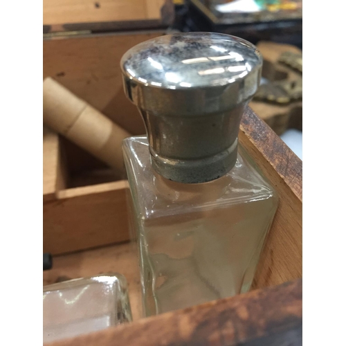 89 - A WOODEN BOX AND CONTENTS TO INCLUDE TWO SILVER PLATED TOP BOTTLES