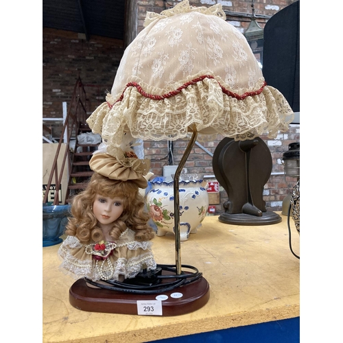 293 - A TABLE LAMP WITH ON A WOODEN BASE WITH CERAMIC LADY'S HEAD DECORATION