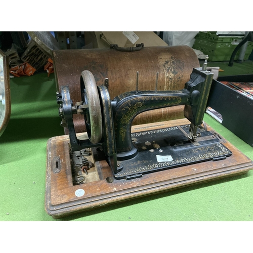 374 - A VINTAGE HAND WIND SEWING MACHINE WITH DECORATED CASE