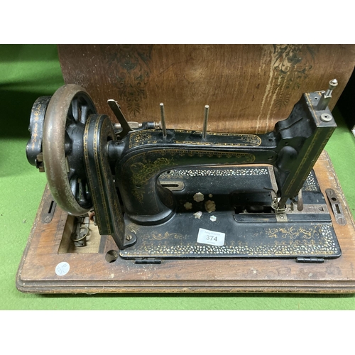 374 - A VINTAGE HAND WIND SEWING MACHINE WITH DECORATED CASE