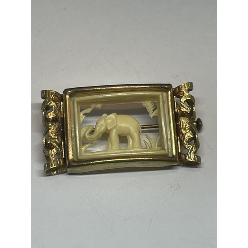 621 - A PINCH BECK BROOCH WITH A BONE ELEPHANT DESIGN