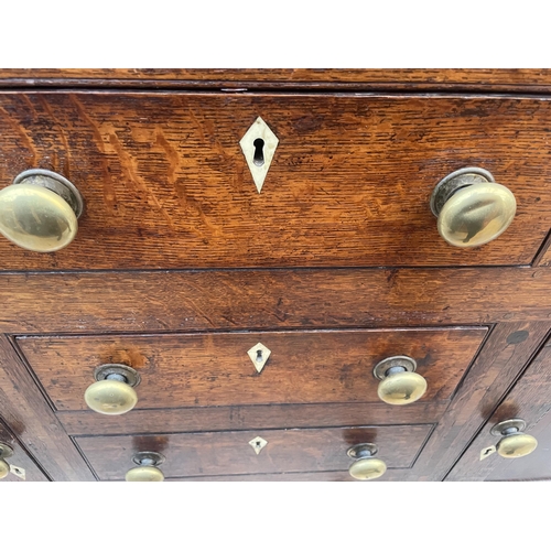 2205 - A GEORGE III OAK DRESSER, THE BASE ENCLOSING THREE LONG AND THREE SHORT DRAWERS AND TWO CUPBOARDS, T... 