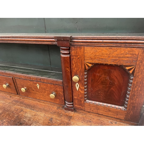 2205 - A GEORGE III OAK DRESSER, THE BASE ENCLOSING THREE LONG AND THREE SHORT DRAWERS AND TWO CUPBOARDS, T... 