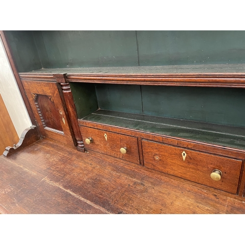 2205 - A GEORGE III OAK DRESSER, THE BASE ENCLOSING THREE LONG AND THREE SHORT DRAWERS AND TWO CUPBOARDS, T... 