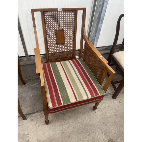 2210 - A 19TH CENTURY SATINWOOD BERGERE FIRESIDE CHAIR ON TAPERING LEGS WITH SPADE FEET